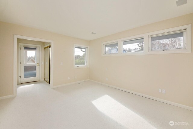 4962 Lilac Dr, Freeland, WA 98249 - carpeted empty room with baseboards and plenty of natural light
