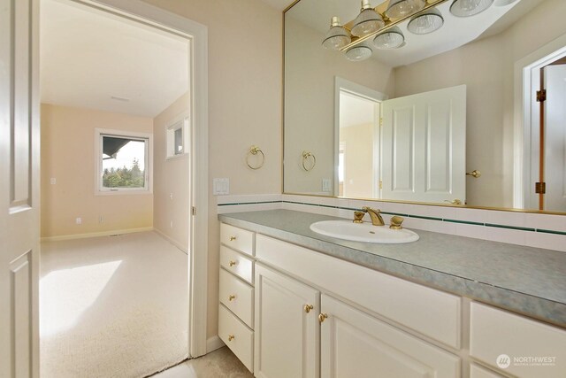 4962 Lilac Dr, Freeland, WA 98249 - bathroom with vanity, a chandelier, and baseboards