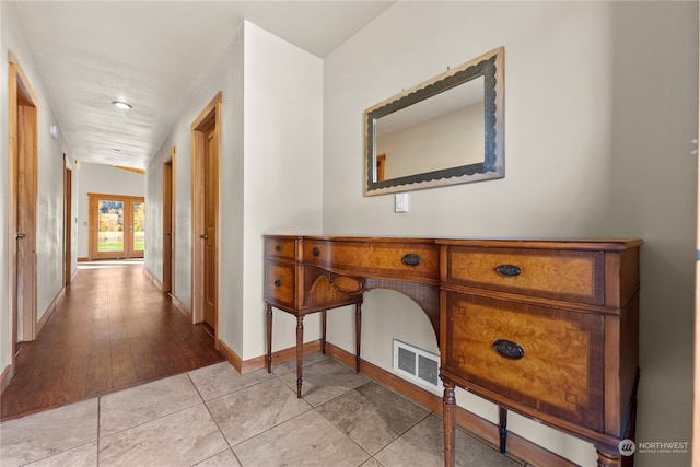 hall featuring french doors and light wood-type flooring