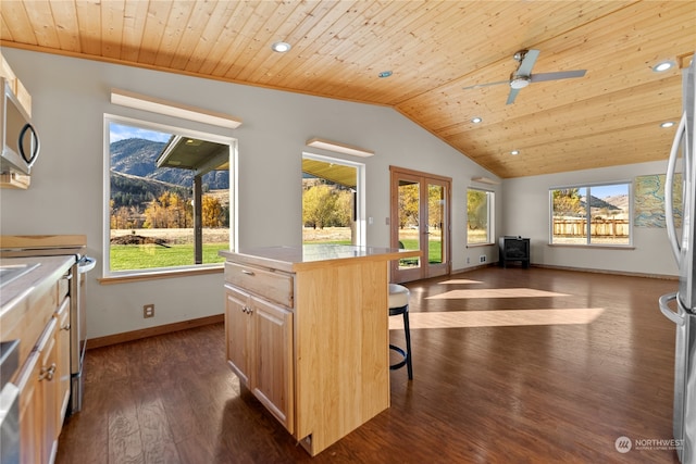 kitchen with a breakfast bar area, dark wood-type flooring, a wealth of natural light, and wooden ceiling