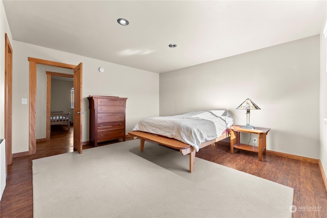 bedroom with dark hardwood / wood-style flooring