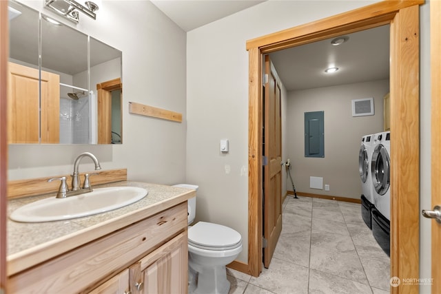 bathroom with washer and clothes dryer, toilet, vanity, a shower, and electric panel