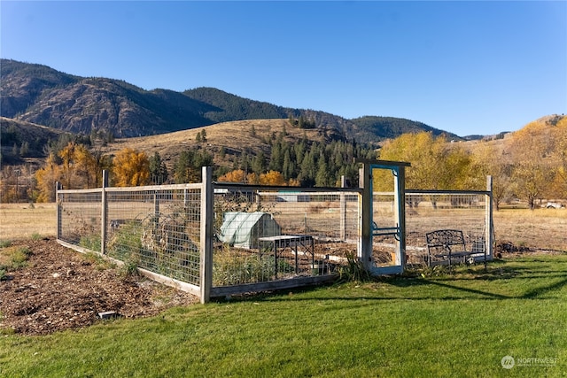 exterior space featuring a rural view, an outdoor structure, and a mountain view