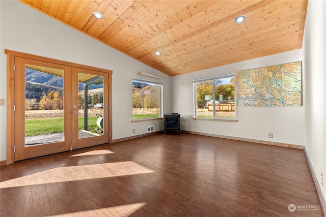 empty room featuring french doors, wood ceiling, a wood stove, vaulted ceiling, and dark hardwood / wood-style floors