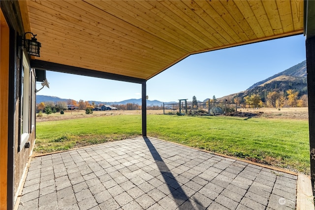 view of patio with a mountain view and a rural view