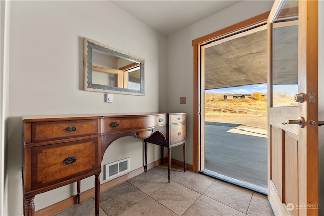 doorway to outside featuring light tile patterned floors