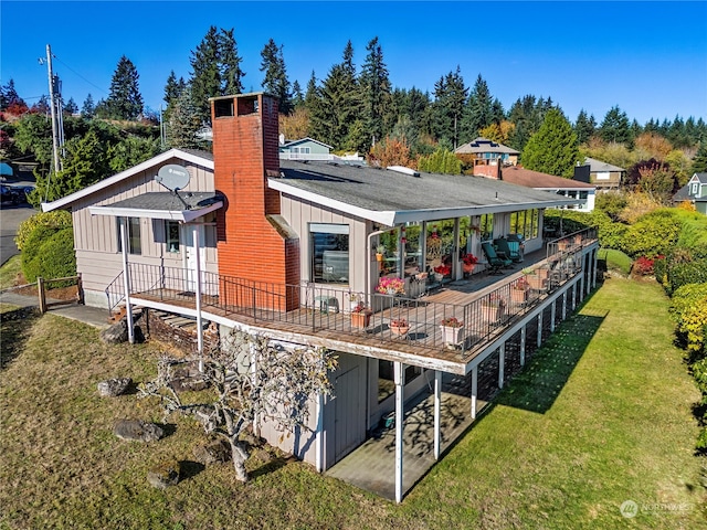 back of house featuring a lawn and a patio