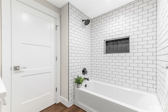 bathroom featuring tiled shower / bath and hardwood / wood-style flooring