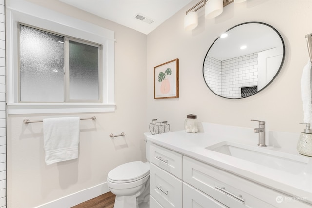 bathroom with vanity, hardwood / wood-style flooring, and toilet