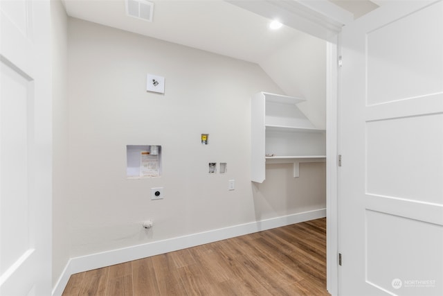 clothes washing area featuring gas dryer hookup, light hardwood / wood-style floors, hookup for a washing machine, and hookup for an electric dryer