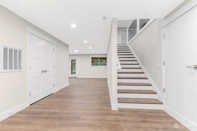 stairs featuring hardwood / wood-style flooring