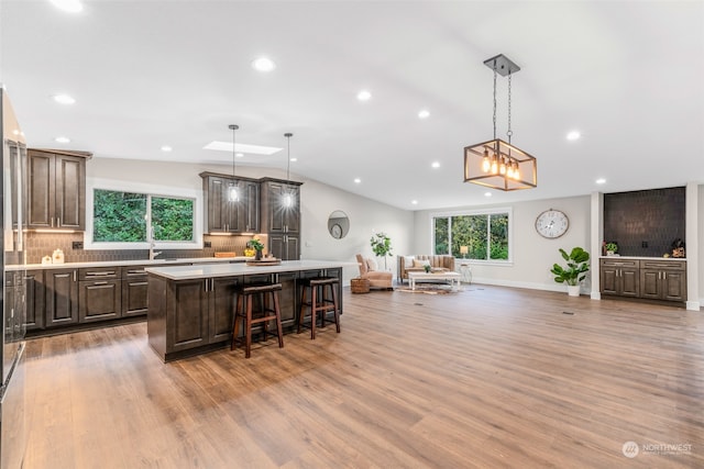 kitchen featuring pendant lighting, hardwood / wood-style flooring, a breakfast bar area, and a center island