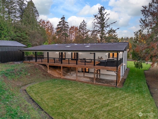 rear view of property with a yard and a deck