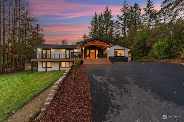 view of front of house with a yard and a deck