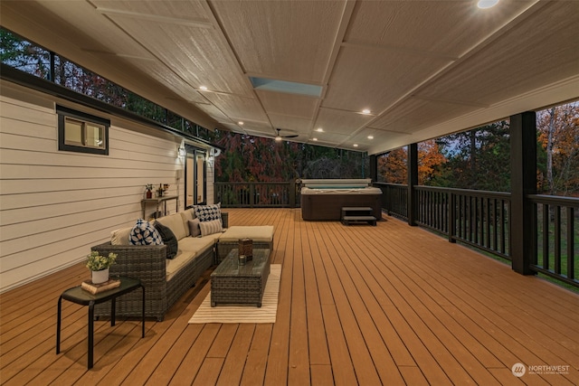 wooden terrace featuring a hot tub and an outdoor living space