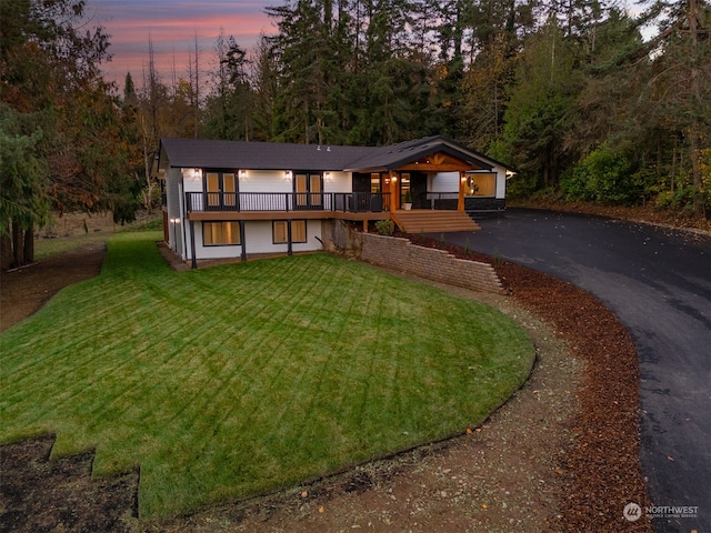 view of front of home with a lawn and a wooden deck