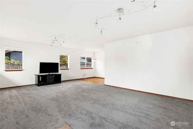 unfurnished living room with a healthy amount of sunlight and light colored carpet