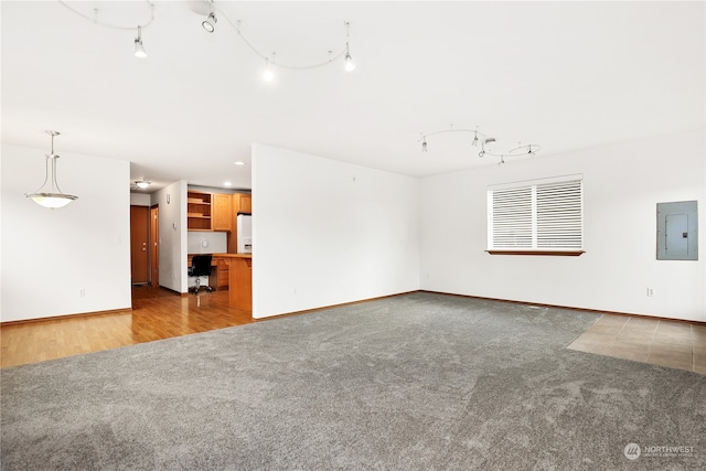 unfurnished living room with electric panel and light wood-type flooring