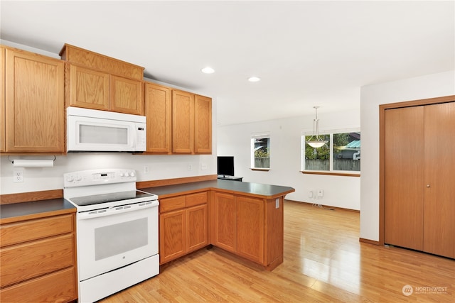 kitchen featuring light hardwood / wood-style flooring, kitchen peninsula, decorative light fixtures, and white appliances