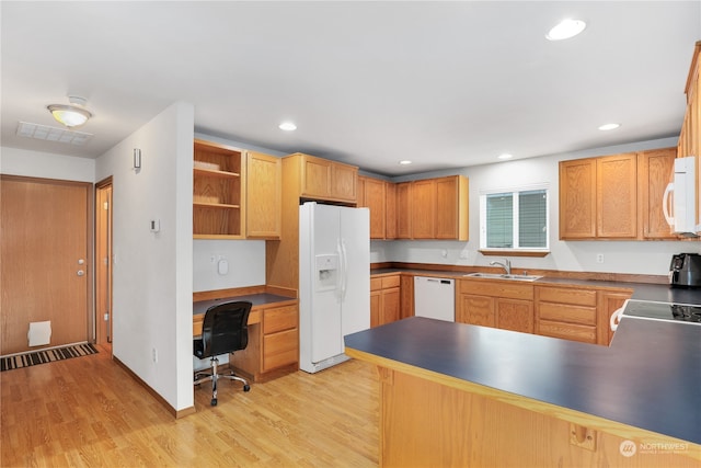 kitchen with white appliances, sink, light wood-type flooring, built in desk, and kitchen peninsula