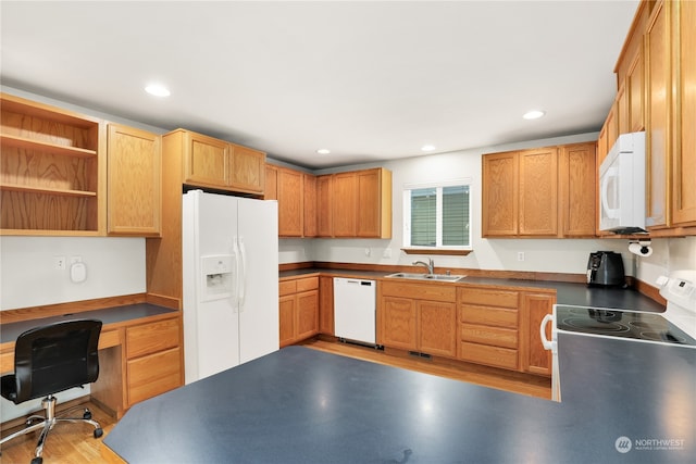 kitchen with built in desk, sink, and white appliances