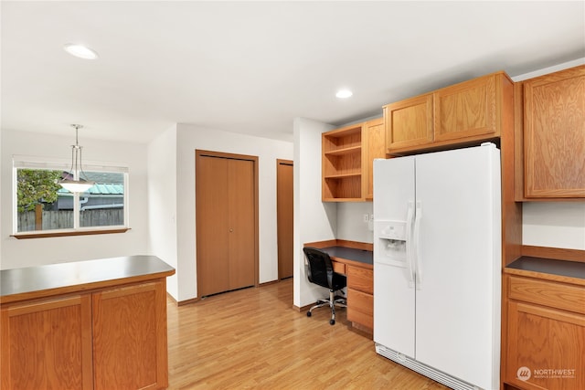 office area featuring built in desk and light hardwood / wood-style floors