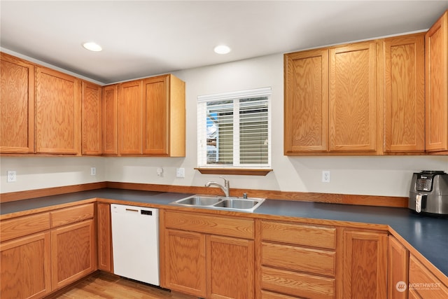 kitchen featuring light hardwood / wood-style floors, sink, and white dishwasher