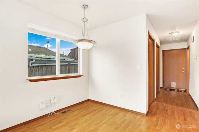 unfurnished dining area featuring hardwood / wood-style floors