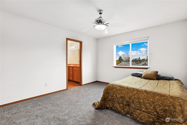 carpeted bedroom featuring ensuite bathroom and ceiling fan