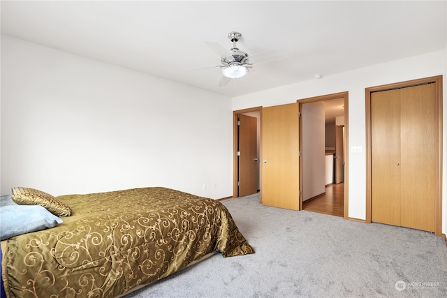 bedroom featuring a closet, light colored carpet, and ceiling fan