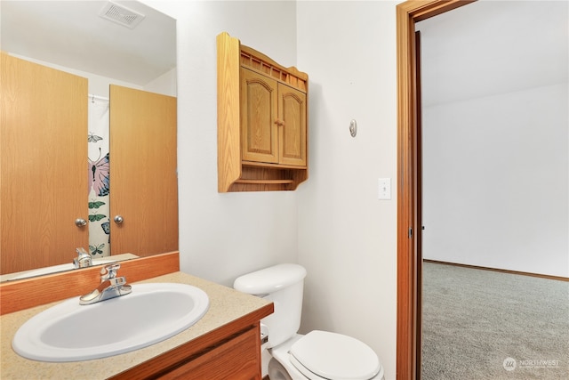 bathroom with toilet and vanity