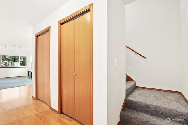 stairs with hardwood / wood-style floors