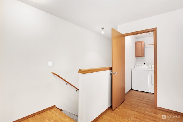 hall with independent washer and dryer and light wood-type flooring