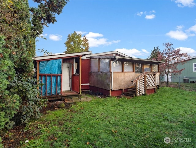 back of house with a lawn