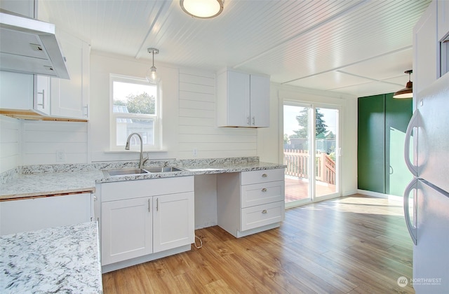 kitchen featuring extractor fan, white cabinetry, plenty of natural light, and pendant lighting