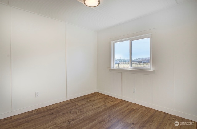 spare room with dark hardwood / wood-style floors