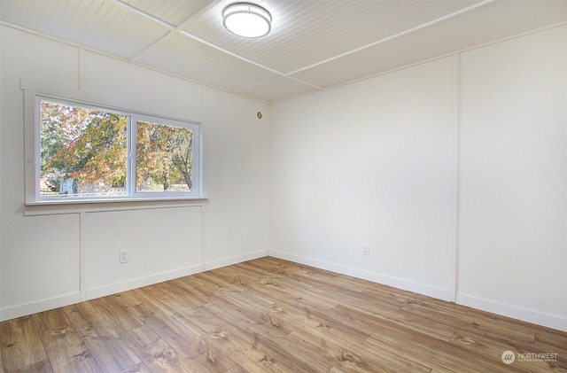 empty room with light hardwood / wood-style flooring