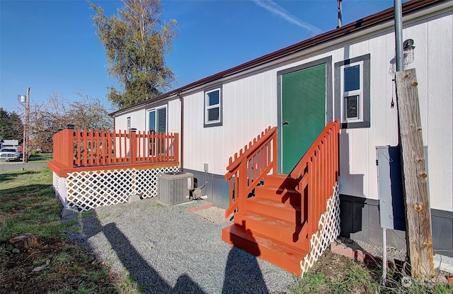 back of property with a wooden deck and central air condition unit