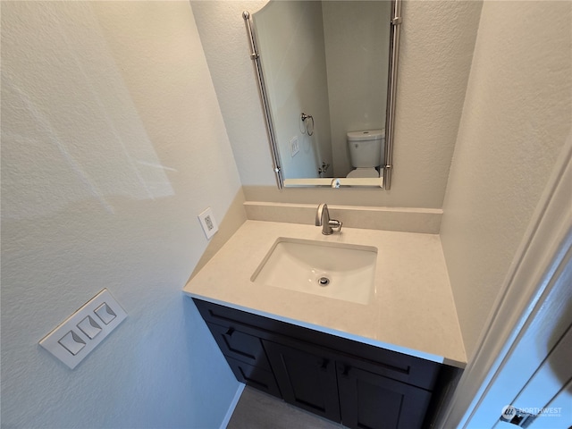 bathroom featuring vanity and toilet