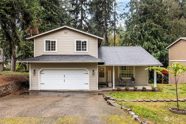 view of front facade with a front yard and a garage