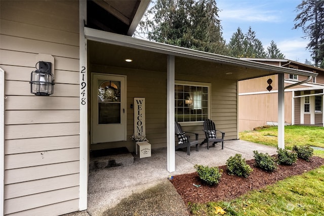 view of exterior entry with a porch