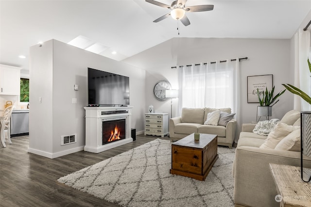 living room featuring vaulted ceiling, ceiling fan, and dark hardwood / wood-style flooring