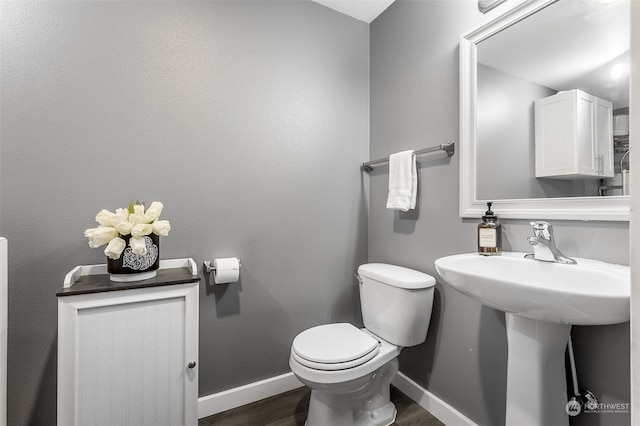 bathroom featuring toilet and hardwood / wood-style flooring