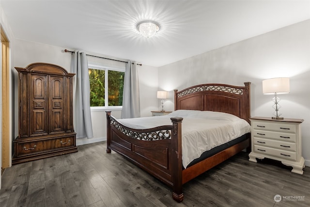 bedroom with dark wood-type flooring