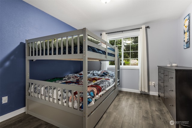 bedroom with dark wood-type flooring