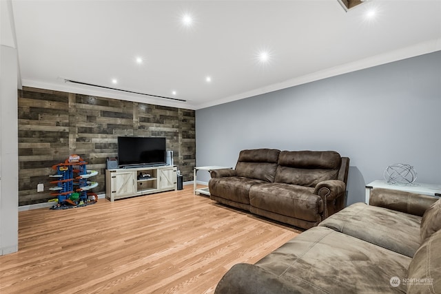 living room featuring crown molding and light hardwood / wood-style flooring