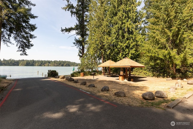 view of property's community with a gazebo and a water view