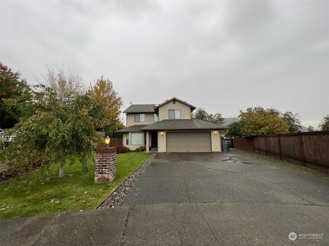 view of front facade with a garage and a front lawn