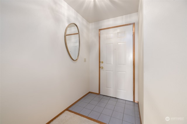 doorway with tile patterned floors