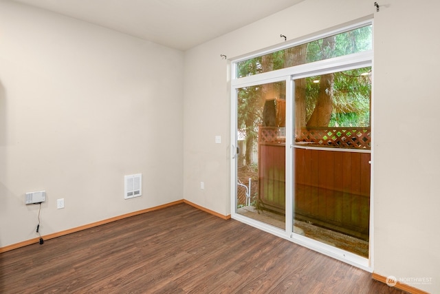 spare room with dark hardwood / wood-style flooring